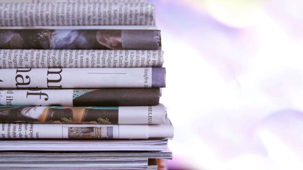 Some newspaper, stacked on bokeh background